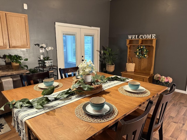 1581 W Lone Pine Dr, Baldwin, MI 49304 - dining room with wood finished floors, french doors, a high ceiling, and baseboards