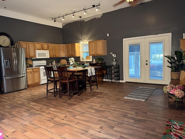 1581 W Lone Pine Dr, Baldwin, MI 49304 - kitchen featuring white appliances, a high ceiling, french doors, track lighting, and wood finished floors