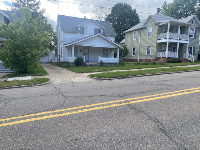 525 NE Eastern Ave NE, Grand Rapids, MI 49503 - view of front of house featuring a porch, an outbuilding, and roof with shingles