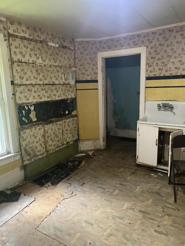 525 NE Eastern Ave NE, Grand Rapids, MI 49503 - interior space featuring wallpapered walls, ornamental molding, and a wainscoted wall