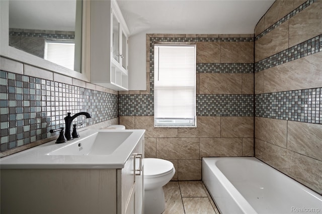 18666 Carrie St, Hamtramck, MI 48234 - bathroom with tile walls, toilet, healthy amount of natural light, a bath, and vanity