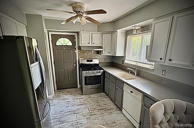 31322 Leota St, Fraser, MI 48026 - kitchen with freestanding refrigerator, stainless steel range with gas cooktop, dishwasher, a sink, and under cabinet range hood