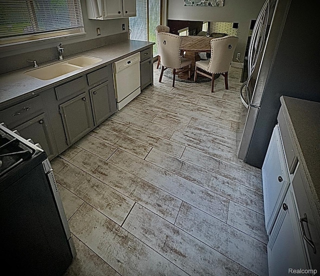 31322 Leota St, Fraser, MI 48026 - kitchen featuring dishwasher, a sink, wood tiled floors, range, and freestanding refrigerator