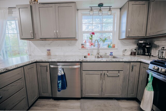 1905 Ora St, Muskegon, MI 49445 - kitchen featuring appliances with stainless steel finishes, a sink, gray cabinetry, and plenty of natural light
