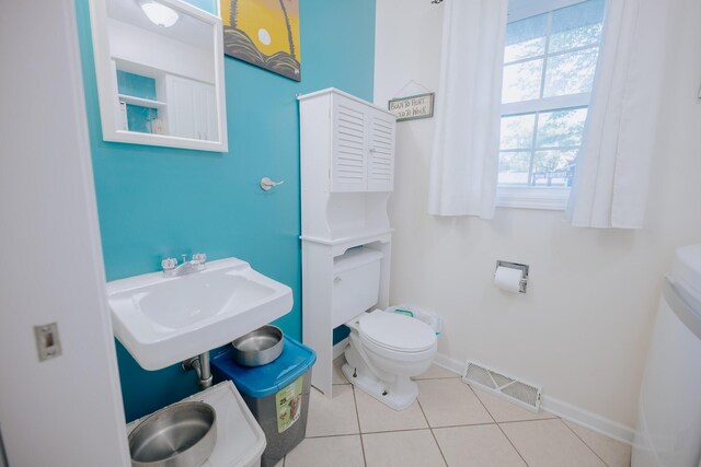 1905 Ora St, Muskegon, MI 49445 - bathroom featuring toilet, a sink, baseboards, and tile patterned floors