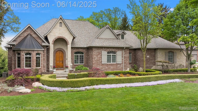 1181 Iroquois Trl, Oxford, MI 48371 - french country style house with roof with shingles, a front lawn, brick siding, and a standing seam roof