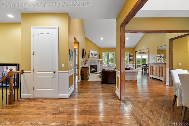 1181 Iroquois Trl, Oxford, MI 48371 - entryway with vaulted ceiling, a glass covered fireplace, wood finished floors, and recessed lighting
