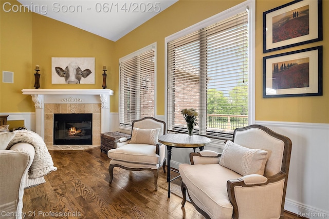 1181 Iroquois Trl, Oxford, MI 48371 - sitting room with wainscoting, vaulted ceiling, wood finished floors, and a tile fireplace