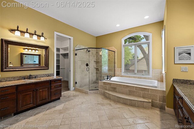 1181 Iroquois Trl, Oxford, MI 48371 - bathroom featuring vanity, a stall shower, a bath, stone tile floors, and recessed lighting