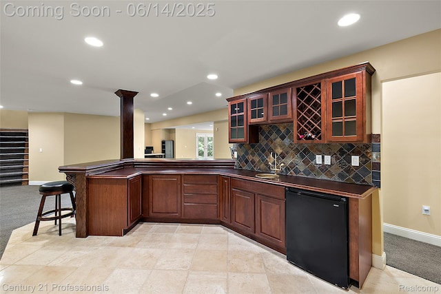 1181 Iroquois Trl, Oxford, MI 48371 - indoor wet bar with refrigerator, decorative columns, backsplash, recessed lighting, and light colored carpet