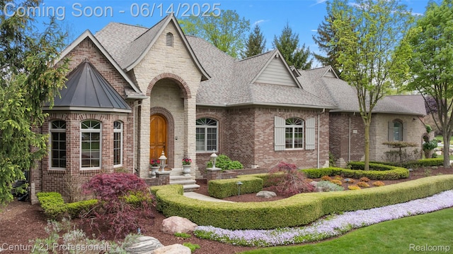 1181 Iroquois Trl, Oxford, MI 48371 - view of front of house featuring a shingled roof and brick siding