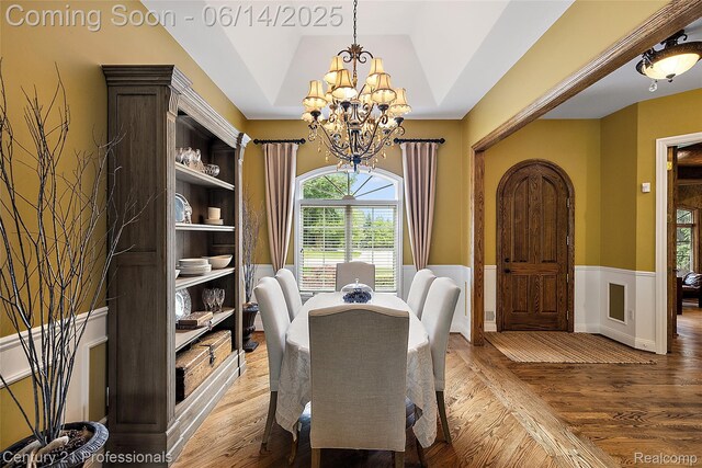 1181 Iroquois Trl, Oxford, MI 48371 - dining area featuring wainscoting, a chandelier, plenty of natural light, and light wood-type flooring