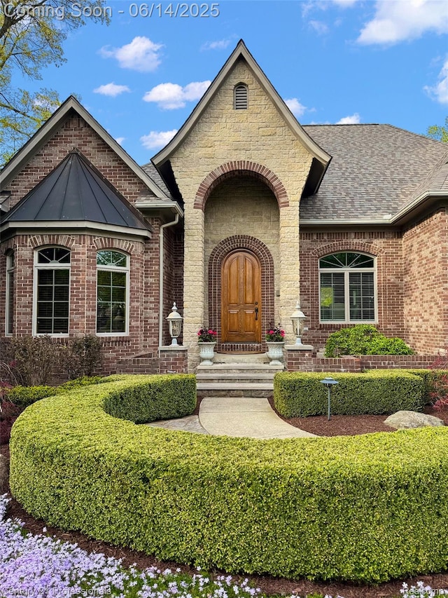 1181 Iroquois Trl, Oxford, MI 48371 - doorway to property featuring brick siding and roof with shingles