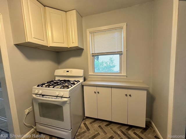 459 E Breckenridge St, Ferndale, MI 48220 - kitchen with white range with gas stovetop, white cabinets, and light countertops