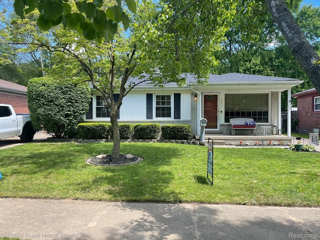 1525 Ackley Ave, Westland, MI 48186 - view of front of home featuring a front lawn, brick siding, and a garage