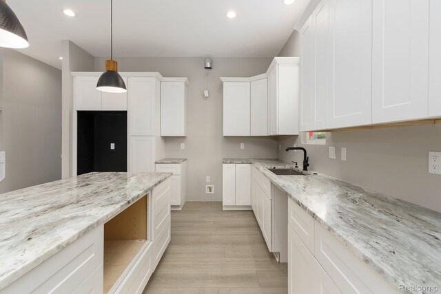 1439 Merry Rd, Waterford, MI 48328 - kitchen featuring a sink, light wood-style floors, recessed lighting, light stone countertops, and white cabinets