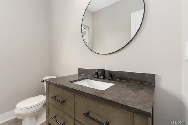 1439 Merry Rd, Waterford, MI 48328 - half bathroom featuring vanity and toilet