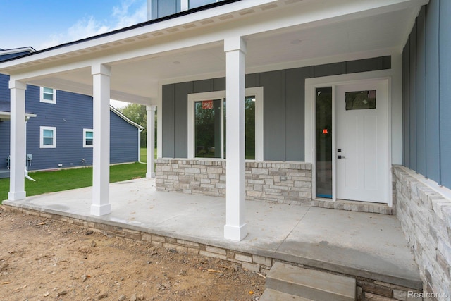 1439 Merry Rd, Waterford, MI 48328 - doorway to property with board and batten siding, covered porch, and stone siding