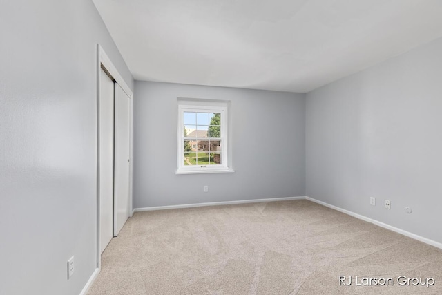 2463 Abbington Dr SE, Grand Rapids, MI 49506 - unfurnished bedroom with light colored carpet and a closet