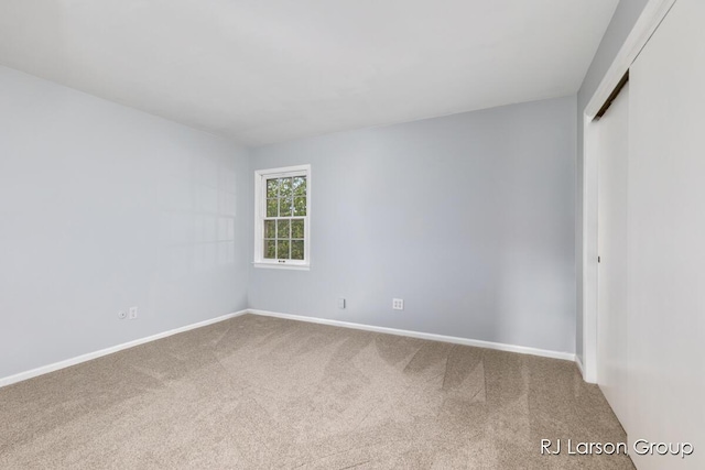 2463 Abbington Dr SE, Grand Rapids, MI 49506 - spare room featuring carpet flooring and baseboards