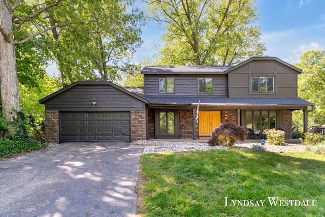 6774 Woodbrook Dr SE, Grand Rapids, MI 49546 - view of front of home with brick siding, driveway, a garage, a front yard, and covered porch