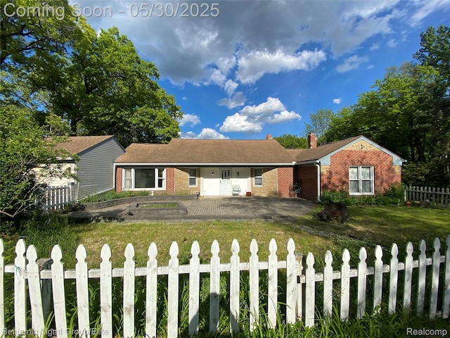 30430 Inkster Rd, Franklin, MI 48025 - ranch-style home with brick siding, a fenced front yard, a chimney, and driveway