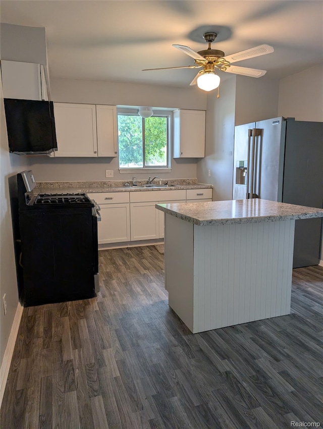 190 Main St, Sebewaing, MI 48759 - kitchen with range with gas stovetop, dark wood-style flooring, high end refrigerator, and white cabinets
