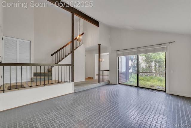 5772 Perrytown Dr, West Bloomfield, MI 48322 - unfurnished living room with high vaulted ceiling, baseboards, stairs, and a chandelier