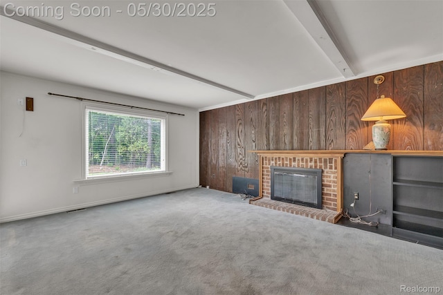5772 Perrytown Dr, West Bloomfield, MI 48322 - unfurnished living room with beam ceiling, wooden walls, a brick fireplace, and carpet flooring