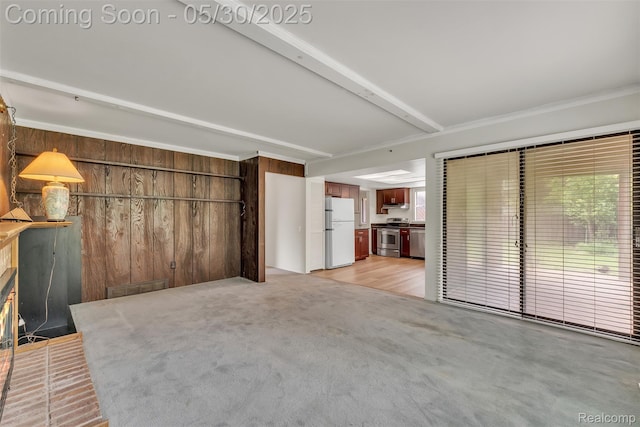 5772 Perrytown Dr, West Bloomfield, MI 48322 - unfurnished living room featuring wooden walls, light colored carpet, and beam ceiling