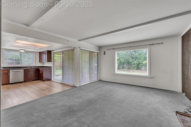 5772 Perrytown Dr, West Bloomfield, MI 48322 - unfurnished living room with healthy amount of natural light, light colored carpet, beam ceiling, and a sink