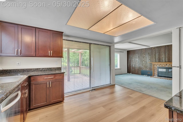 5772 Perrytown Dr, West Bloomfield, MI 48322 - kitchen with dishwasher, a sink, open floor plan, light wood-style flooring, and wood walls