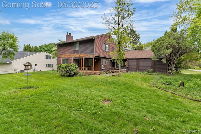 5772 Perrytown Dr, West Bloomfield, MI 48322 - rear view of property with a chimney, a yard, and a deck