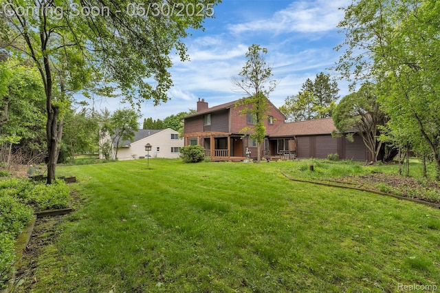 5772 Perrytown Dr, West Bloomfield, MI 48322 - rear view of property featuring a chimney and a yard