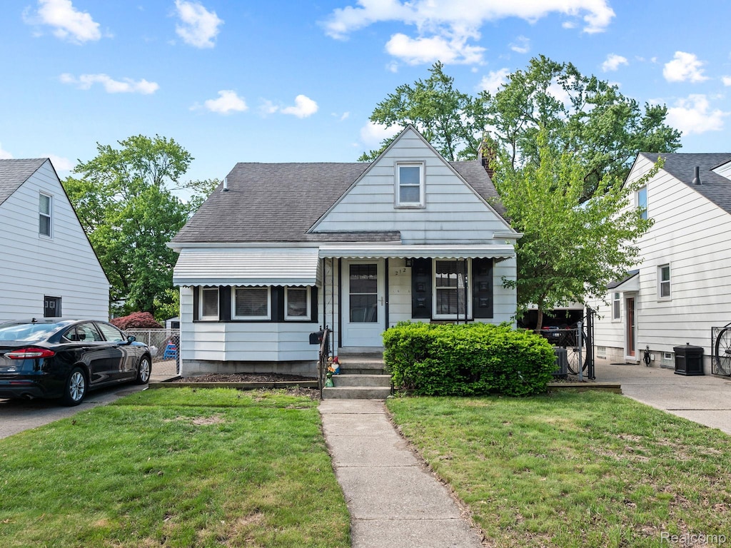 212 Devillen Ave, Royal Oak, MI 48073 - bungalow-style house featuring a front yard, roof with shingles, and central AC
