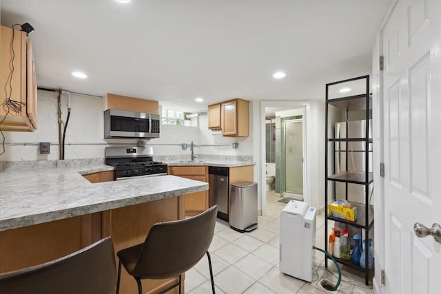 3364 Inman St, Ferndale, MI 48220 - kitchen featuring stainless steel appliances, a sink, light countertops, a breakfast bar area, and a peninsula