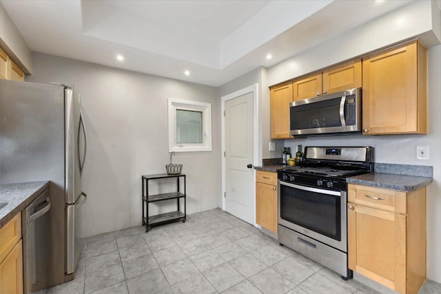 3364 Inman St, Ferndale, MI 48220 - kitchen featuring stainless steel appliances, recessed lighting, dark countertops, a raised ceiling, and light tile patterned flooring