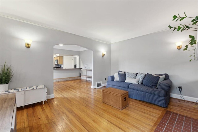 3364 Inman St, Ferndale, MI 48220 - living room with arched walkways, light wood-style floors, and baseboards