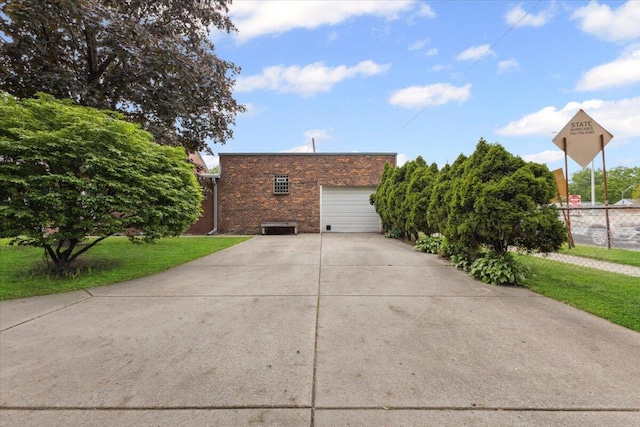 3364 Inman St, Ferndale, MI 48220 - view of side of property featuring brick siding, driveway, and a garage