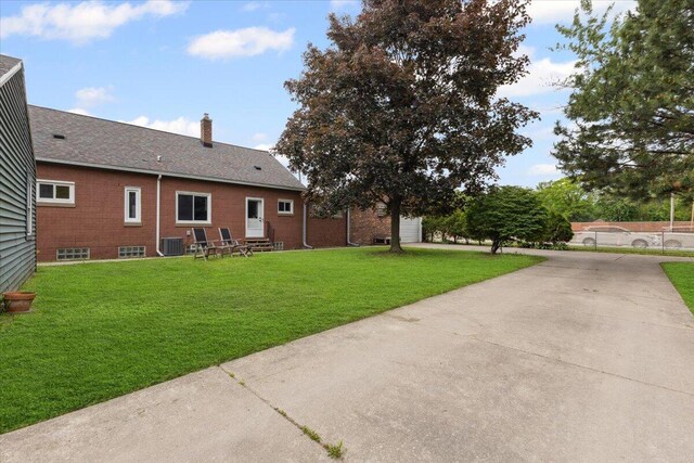 3364 Inman St, Ferndale, MI 48220 - view of green lawn with cooling unit, driveway, entry steps, and a garage