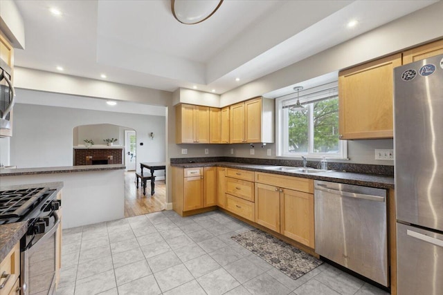 3364 Inman St, Ferndale, MI 48220 - kitchen featuring appliances with stainless steel finishes, a sink, arched walkways, recessed lighting, and dark countertops