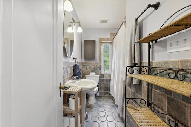3364 Inman St, Ferndale, MI 48220 - bathroom with tile walls, toilet, wainscoting, and tile patterned floors