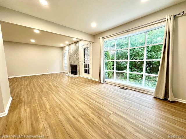 31404 Hunters Circle Dr, Farmington, MI 48334 - unfurnished living room featuring baseboards, light wood-style floors, a premium fireplace, and recessed lighting