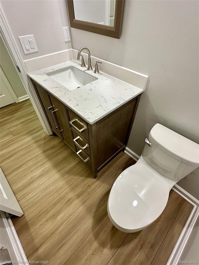 31404 Hunters Circle Dr, Farmington, MI 48334 - half bath featuring vanity, wood finished floors, and toilet