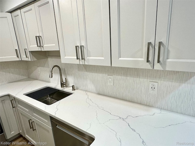 31404 Hunters Circle Dr, Farmington, MI 48334 - kitchen featuring a sink, tasteful backsplash, light stone countertops, and white cabinets