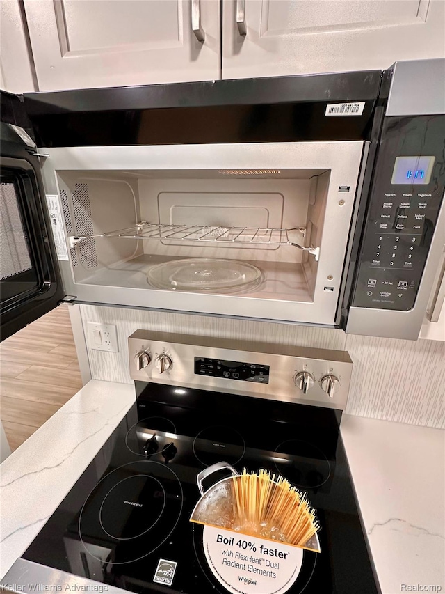 31404 Hunters Circle Dr, Farmington, MI 48334 - kitchen view of stainless steel appliances and light stone countertops