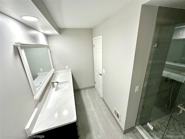 31404 Hunters Circle Dr, Farmington, MI 48334 - full bath with double vanity, a shower stall, baseboards, and wood finished floors