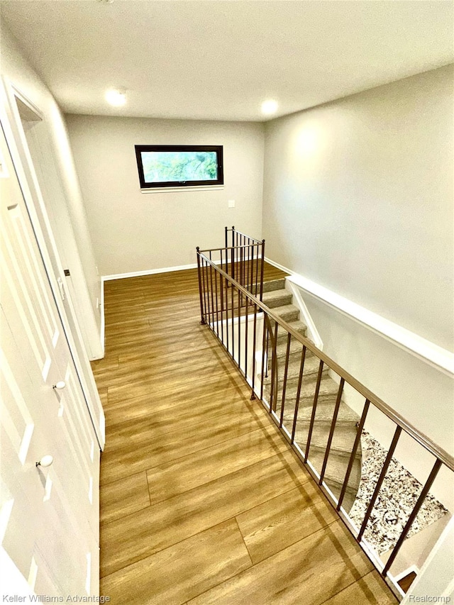 31404 Hunters Circle Dr, Farmington, MI 48334 - staircase with wood finished floors, a textured ceiling, and baseboards