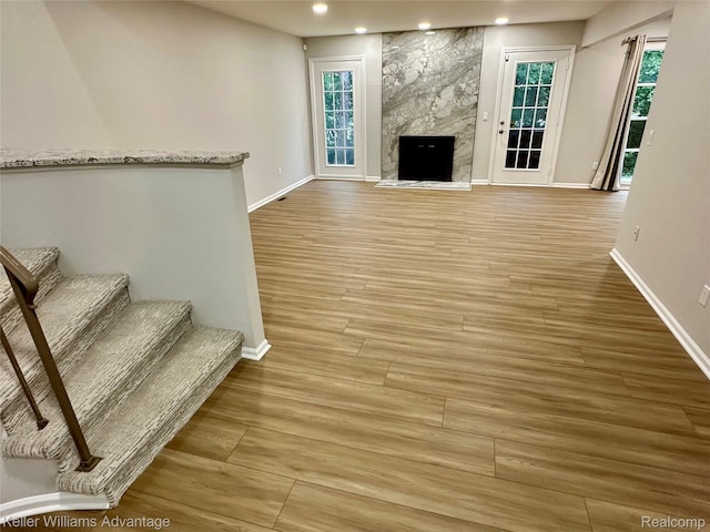 31404 Hunters Circle Dr, Farmington, MI 48334 - unfurnished living room with baseboards, recessed lighting, plenty of natural light, light wood finished floors, and a fireplace