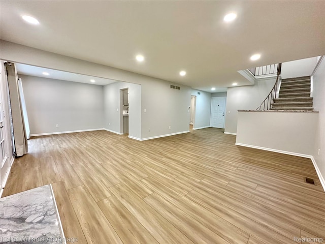 31404 Hunters Circle Dr, Farmington, MI 48334 - unfurnished living room featuring recessed lighting, light wood finished floors, baseboards, and stairs